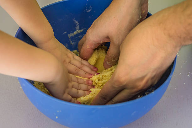 istock Children and dad hands preparing shortbread dough 622289150