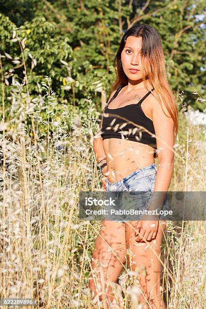 Young Caucasian Girl Enjoying In A Wheat Field Stock Photo - Download Image Now - Adult, Adults Only, Agricultural Field