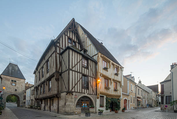 Square with half-timbered houses, in the medieval village Noyers Noyers-Sur-Serein, France - October 11, 2016: Sunset view of the main square (place de hotel de ville), with half-timbered houses, in the medieval village Noyers-sur-Serein, Burgundy, France avallon stock pictures, royalty-free photos & images