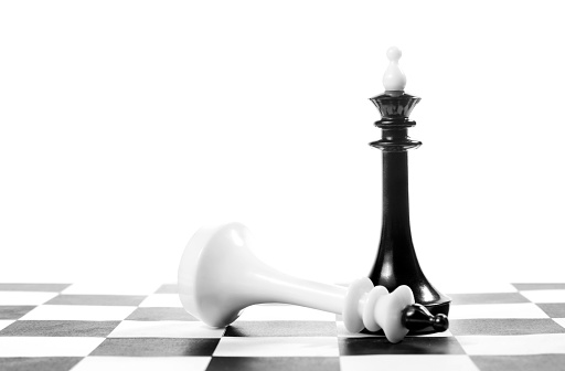 Chess king won another one. Victory and defeat. Concept with chess pieces against white background