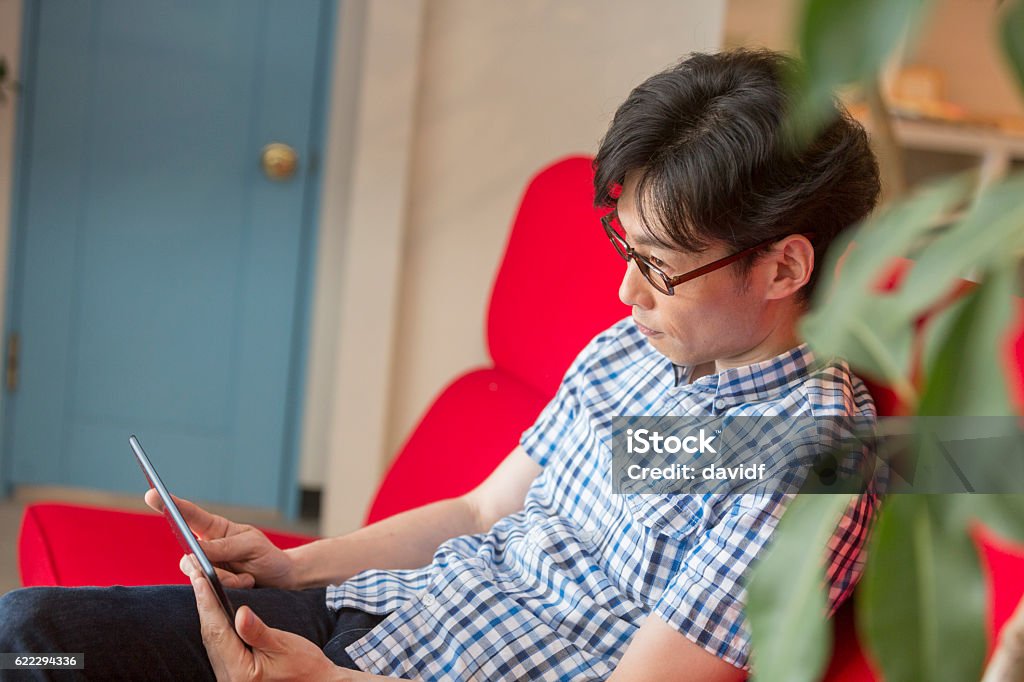 Japanese Man Using Computer Young Japanese Men Using A Tablet Computer At Home Stock Photo ...