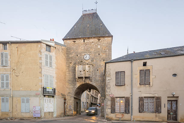 The entry gate ,Noyers-sur-Serein Noyers-Sur-Serein, France - October 12, 2016: Sunrise view of the entry gate (porte dAvallon), in the medieval village Noyers-sur-Serein, Burgundy, France avallon stock pictures, royalty-free photos & images