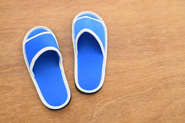 istock Blue house slippers on wooden background 622299736