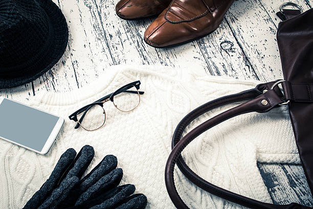Pile of autumn winter fashion knits denim and belt fashionable still lifePhoto taken indoors