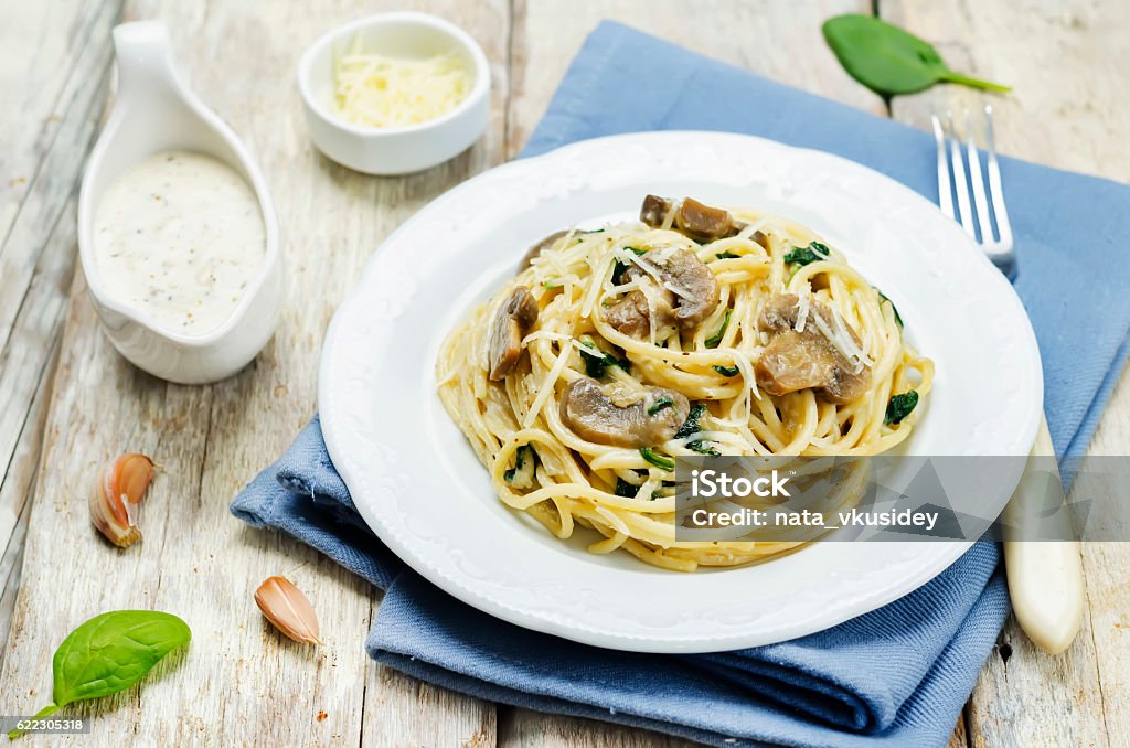 Creamy mushroom spinach pasta Creamy mushroom spinach pasta. toning. selective focus Cheese Stock Photo