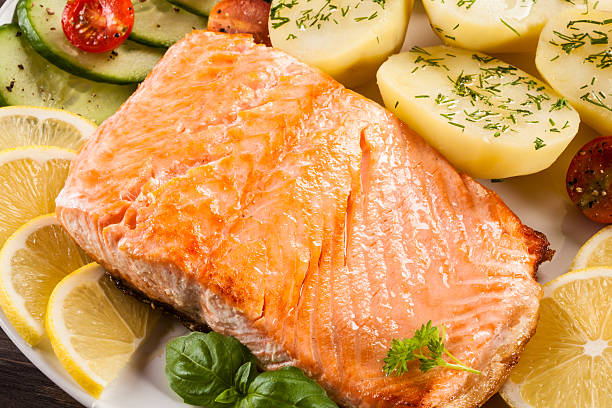 istock Fried salmon, boiled potatoes and vegetable salad 622305336