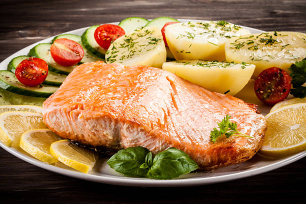 istock Fried salmon, boiled potatoes and vegetable salad 622305500