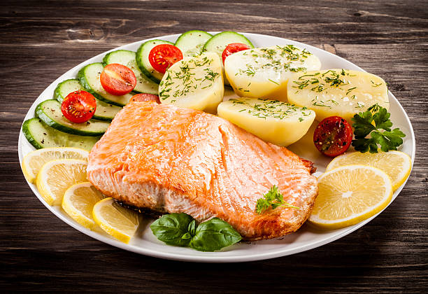 istock Fried salmon, boiled potatoes and vegetable salad 622305698