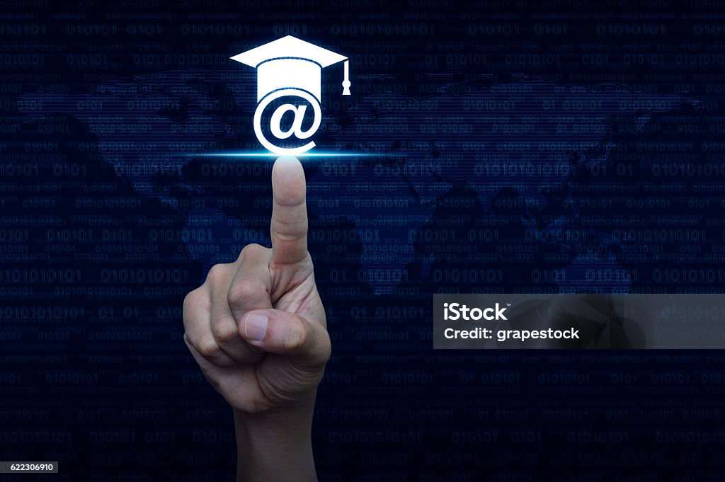 Hand pressing e-learning icon over computer binary code Hand pressing e-learning icon over computer binary code blue background, Study online concept E-Learning Stock Photo