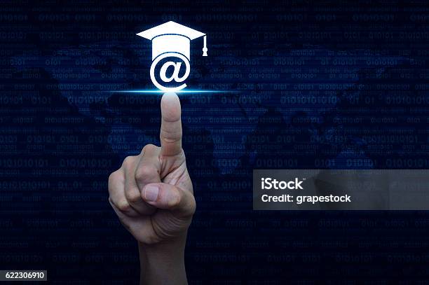 Hand Pressing Elearning Icon Over Computer Binary Code Stock Photo - Download Image Now