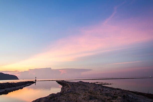 istock Sunset and beach with light the fisherman and background 622307654