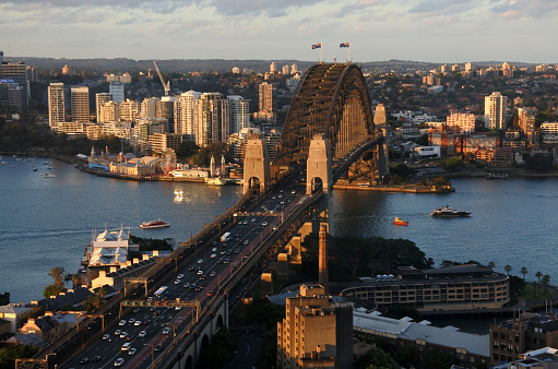 Aerial urban landscape view of Sydney Harbour Bridge at sunset with North Sydney and The Rocks in Sydney New South Wales, Australia.