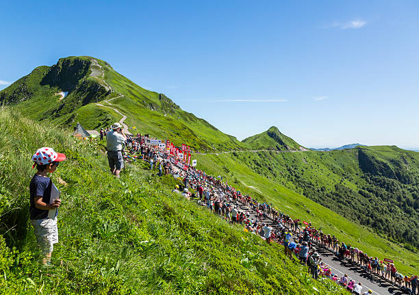 The Peloton in Mountains - Tour de France 2016 Pas De Peyrol, France - July 6, 2016: The peloton riding on the road to Pas de Pyerol (Puy Mary) in Cantal in the Central Massif during the stage 5 of Tour de France on July 6, 2016. tour de france stock pictures, royalty-free photos & images