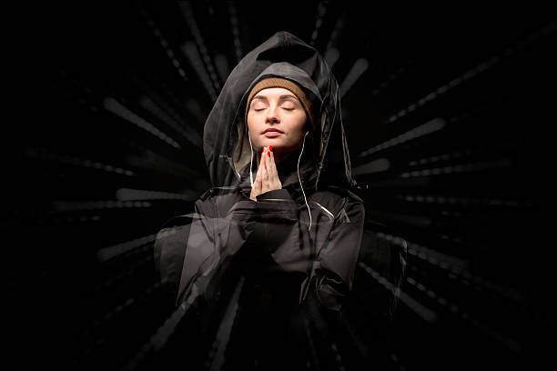 girl praying, black background.