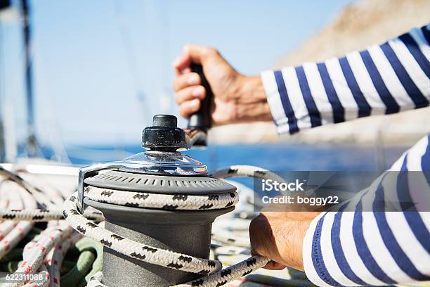 Man In Action Of Pulling Rope Stock Photo - Download Image Now - Sailboat, Sailing, Crew