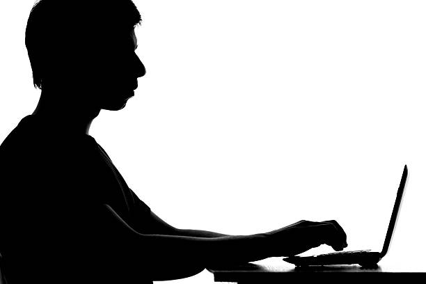 istock silhouette of a student learning remotely with the Internet u 622311284
