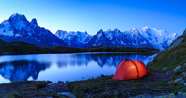 Chéserys sunrise Red tent at Lac De Chéserys, in the mountains near Chamonix, France, at a blue dawn. mont blanc photos stock pictures, royalty-free photos & images