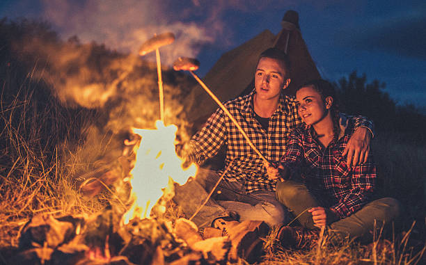 istock Couple preparing sausages on bonfire 622313958