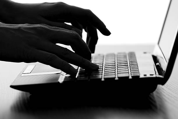 istock silhouette of a female hands typing on the keyboard 622315038