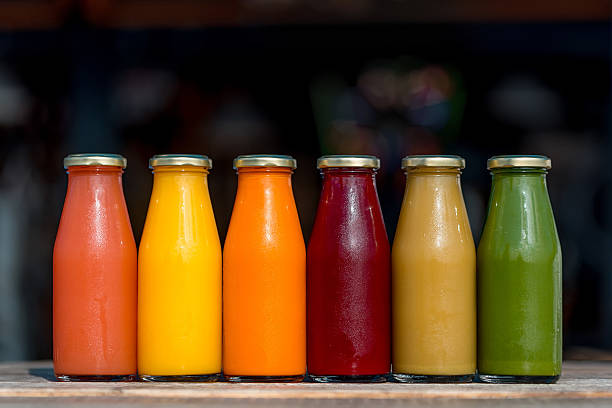 Raw vegetable and fruit juices in glass bottles