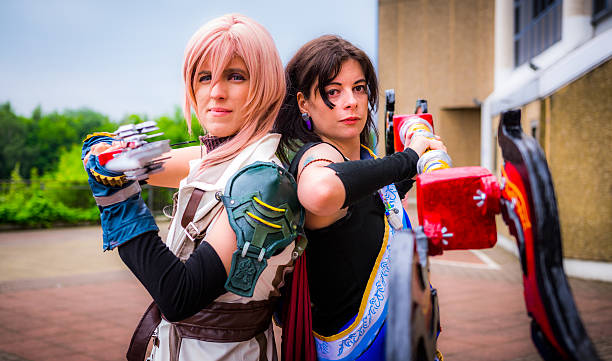 Cosplayers dressed as 'Lightning' and 'Fang' from 'Final Fantasy Sheffield, United Kingdom - June 11, 2016: Cosplayers dressed as 'Lightning' and 'Fang' from the video game 'Final Fantasy Xiii' at the Yorkshire Cosplay Convention at Sheffield Arena cosplay photos stock pictures, royalty-free photos & images
