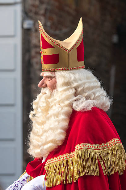 Sinterklaas arriving in The Netherlands for the Sint Nicolaas festival Kampen, The Netherlands - November 12, 2016: Arrival of Sinterklaas in the city of Kampen, The Netherlands. The old Saint Nicholas is riding his horse through the crowded shopping street surrounded by his helpers the Black Petes. Sinterklaas is a traditional Dutch holiday for children that is celebrated on the 5th of December. In recent year there is a strong discussion about the role of Zwarte Piet in this cultural tradition. zwarte piet stock pictures, royalty-free photos & images