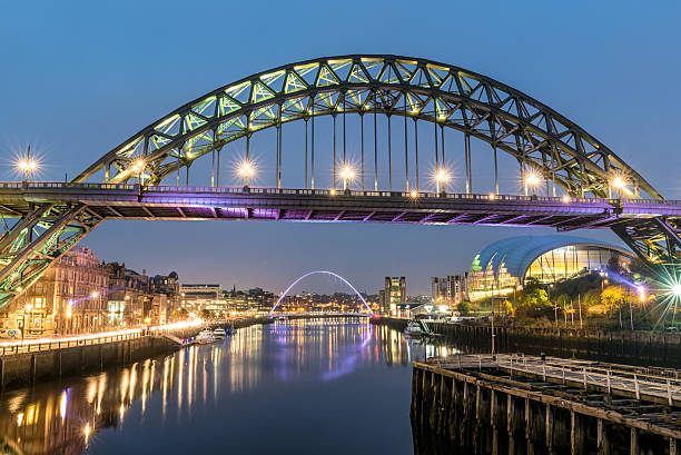 Tyne Bridges River Tyne in Newcastle upon Tyne, North East England at sunset with the Gateshead Millennium bridge, Sage Arts Centre building and reflections tyne bridge stock pictures, royalty-free photos & images