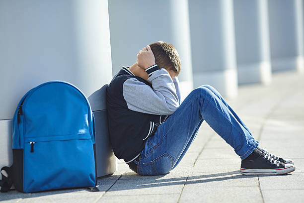istock schoolboy crying on the street 622317542