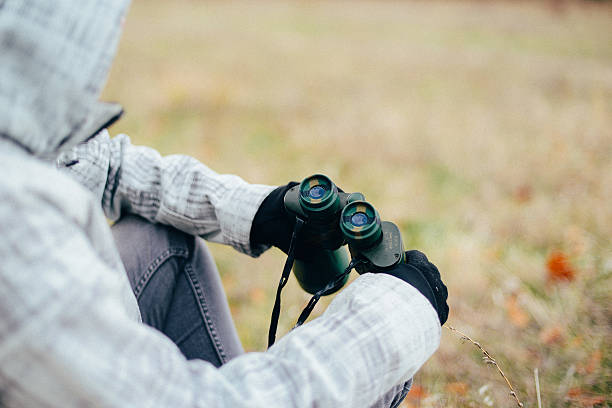 istock Young woman looking through binoculars on a autumn nature. Binoc 622317564