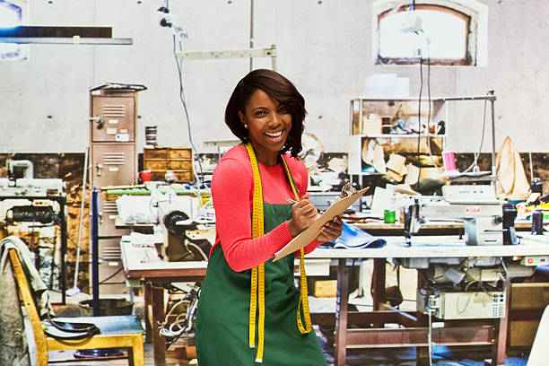 istock Smiling seamstress working in textile industry 622319928