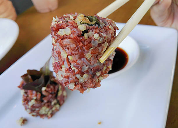 istock Rice Berry and vegtable Sushi rolls holding by chopsticks 622321888