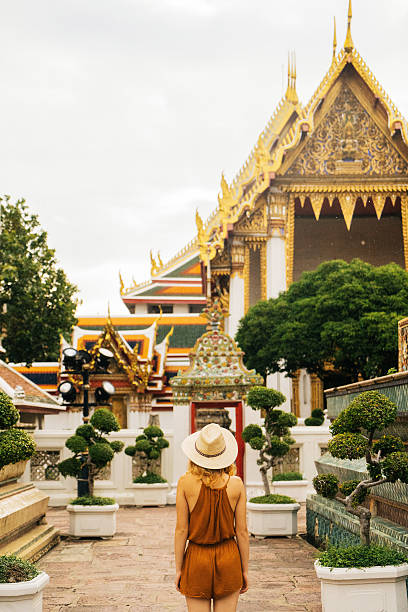 istock Woman walking in Wat Pho temple 622323910