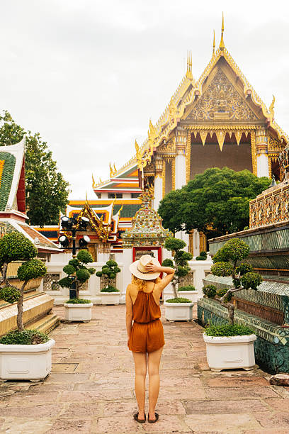 istock Woman walking in Wat Pho temple 622323914