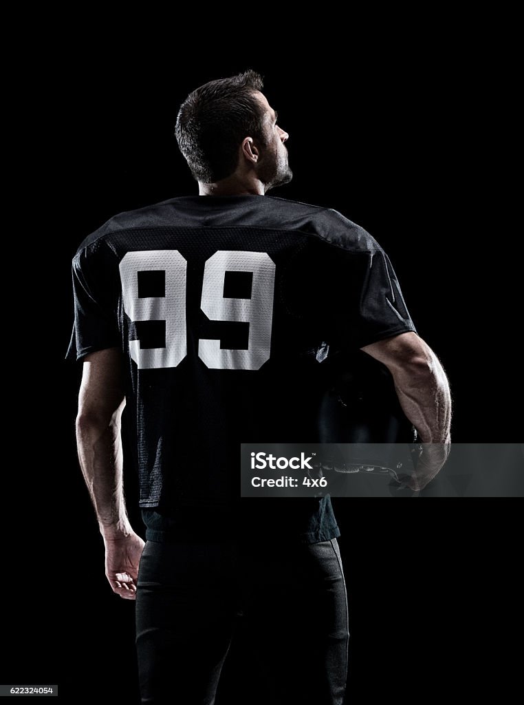 Rear view of American football player standing 30-39 Years Stock Photo Rear view of American football player standing 30-39 Years Stock Photo