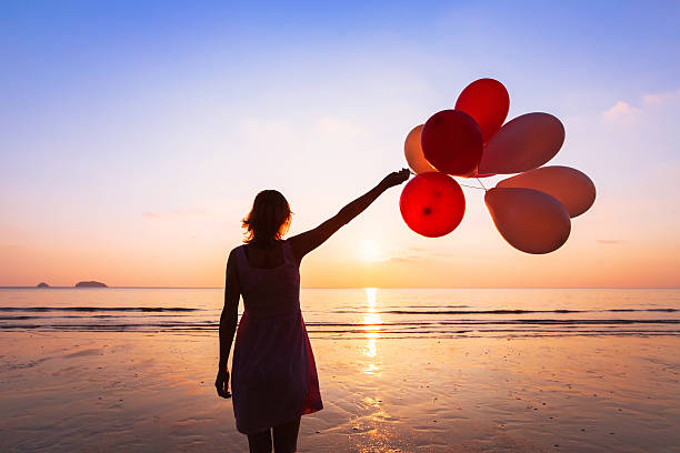 imagination and creativity imagination and creativity, girl with multicolored balloons at sunset with copyspace, inspiration concept releasing stock pictures, royalty-free photos & images