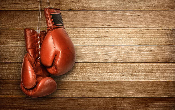 Boxing gloves hanging Hang up the gloves, old leather boxing gloves hanged on wooden wall knockout stock pictures, royalty-free photos & images