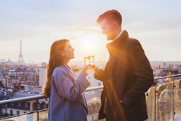istock happy couple drinking champagne in Paris 622419656
