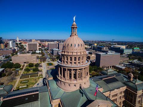 Texas State Capitol Building Over Austin Texas with American and Texas Flag flying above the Governmental Capitol building 