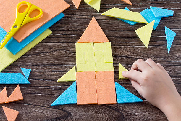 istock Hand assembled child figure ship Tangram puzzle square 622423570