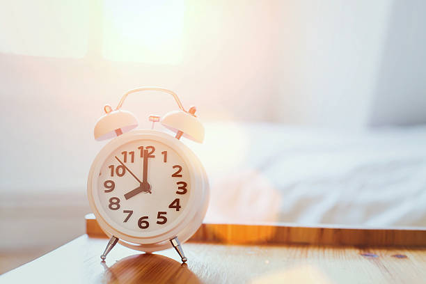 morning time background, alarm clock morning time background, alarm clock near the bed at home alarm clock stock pictures, royalty-free photos & images