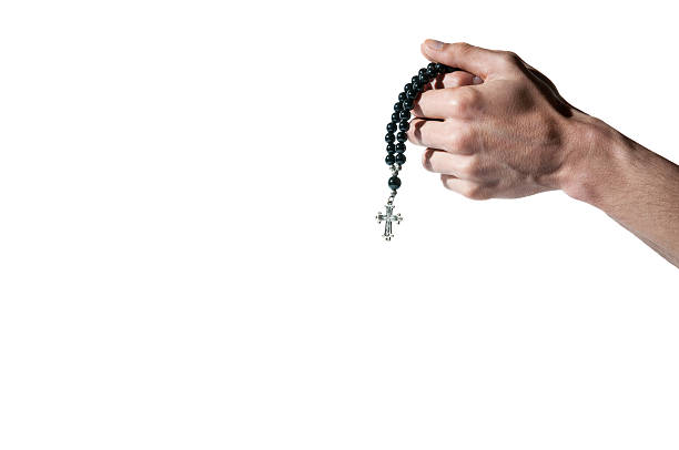 praying hands holding a rosary with cross - confessional nun catholic imagens e fotografias de stock