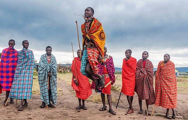 Masai Mara, Kenya  - March 7, 2016: Masai warriors dancing traditional jumps as cultural ceremony