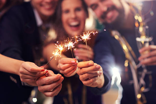 Group of friends having fun with sparklers stock photo