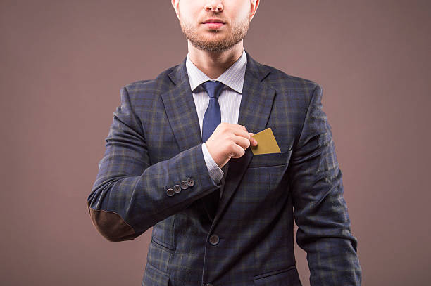 istock Charismatic man in suit puts the card 622439804