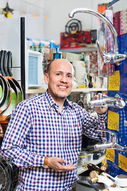 istock Mature man selecting heating water tap in  store 622440098