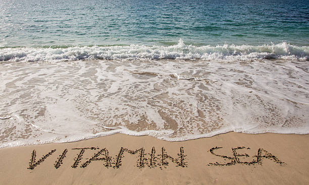 istock Vitamin sea written in the sand on the beach 622440124
