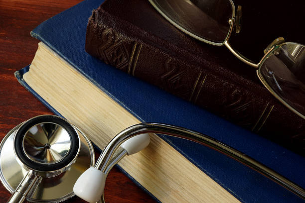 istock Stethoscope with books on a wooden background. 622440574