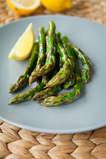 istock Green asparagus with lemon juice. 622441062