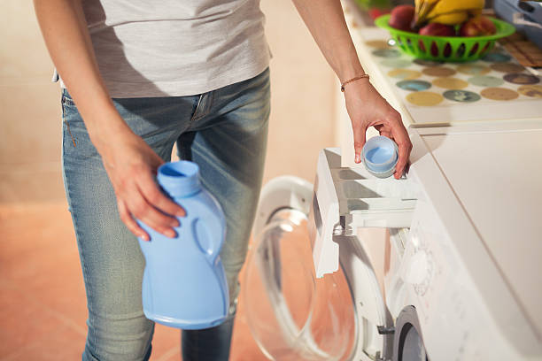 istock Householder woman using conditioner for washing machine 622443312