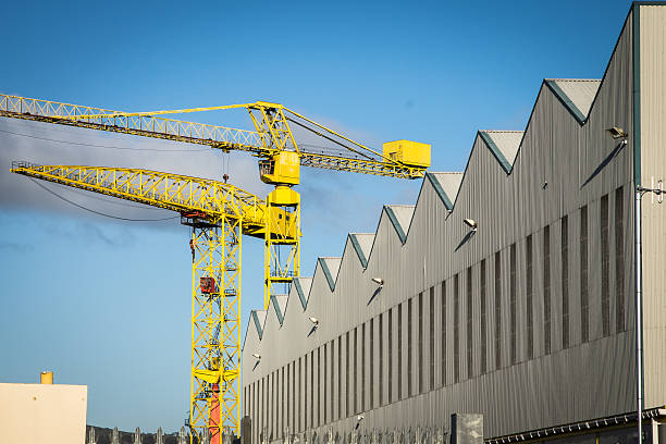 istock Two yellow cranes and industrial building 622445630